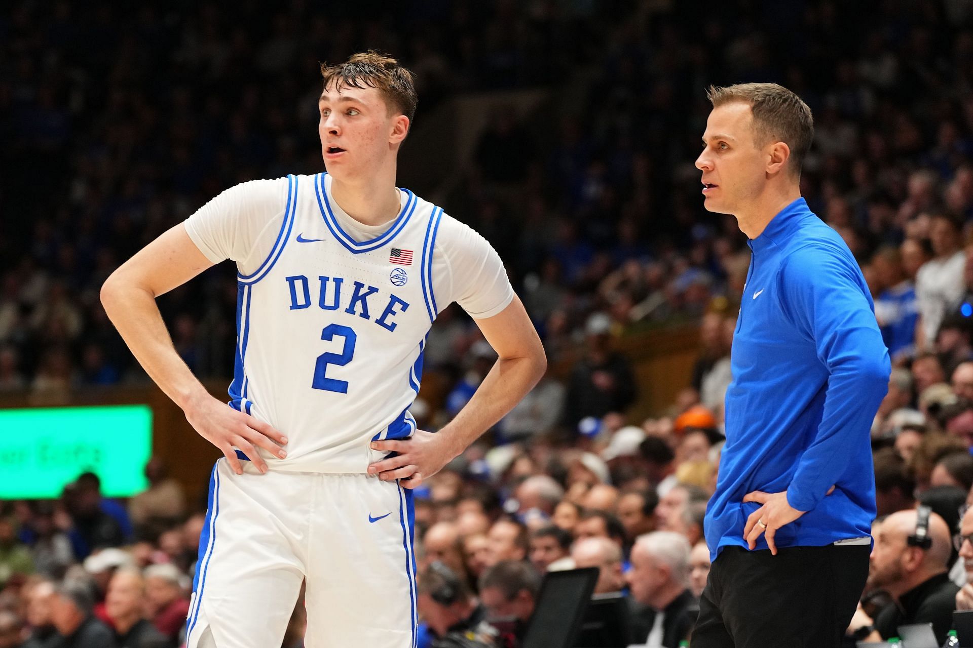 Cooper Flagg (#2) talks with coach Jon Scheyer of the Duke Blue Devils